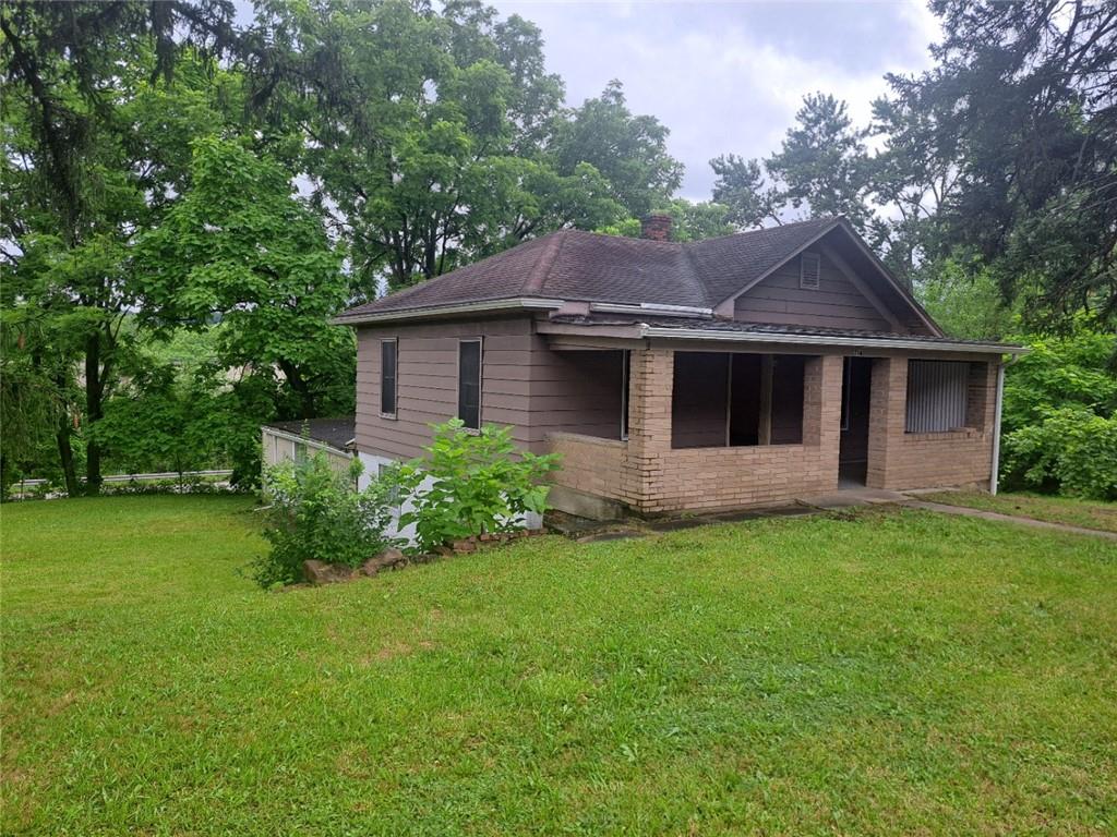 a front view of a house with a garden
