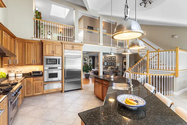 a dining room with furniture and a floor to ceiling window