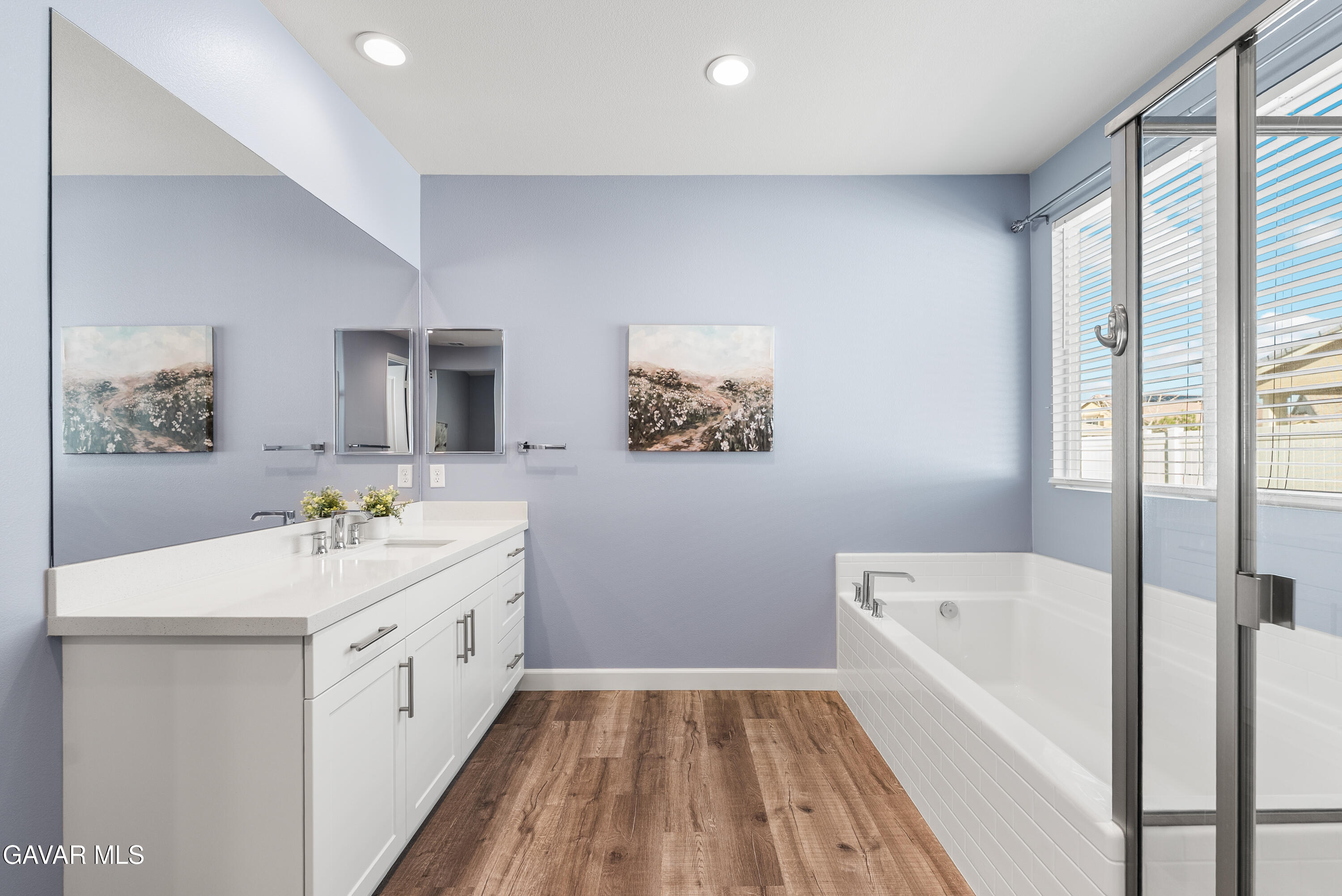 2108 Cork Oak Street Palmdale, CA 93551 - Photo 47 of 55 a bathroom with a sink a large mirror and a bathtub