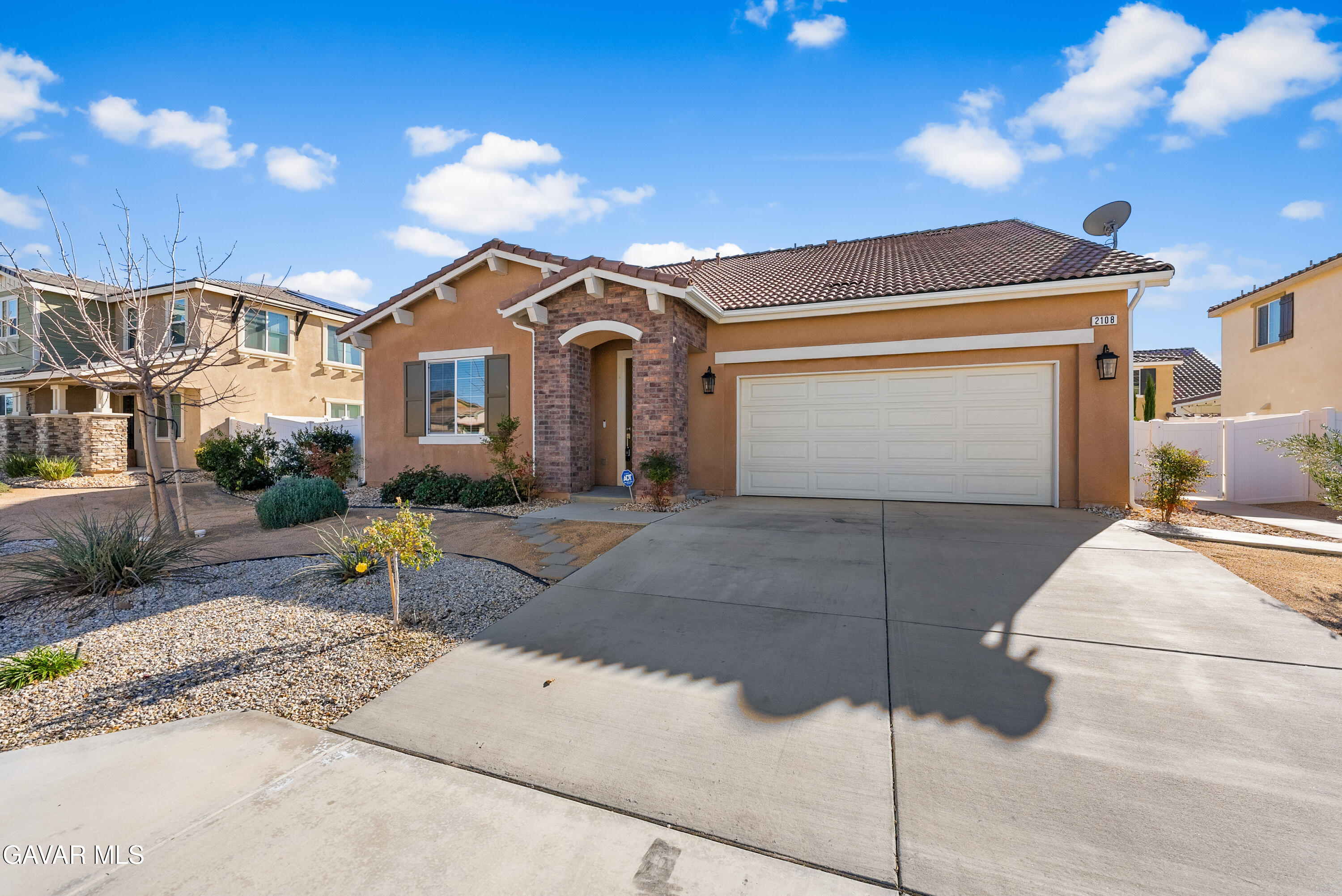 2108 Cork Oak Street Palmdale, CA 93551 - Photo 49 of 55 a front view of a house with a yard and garage