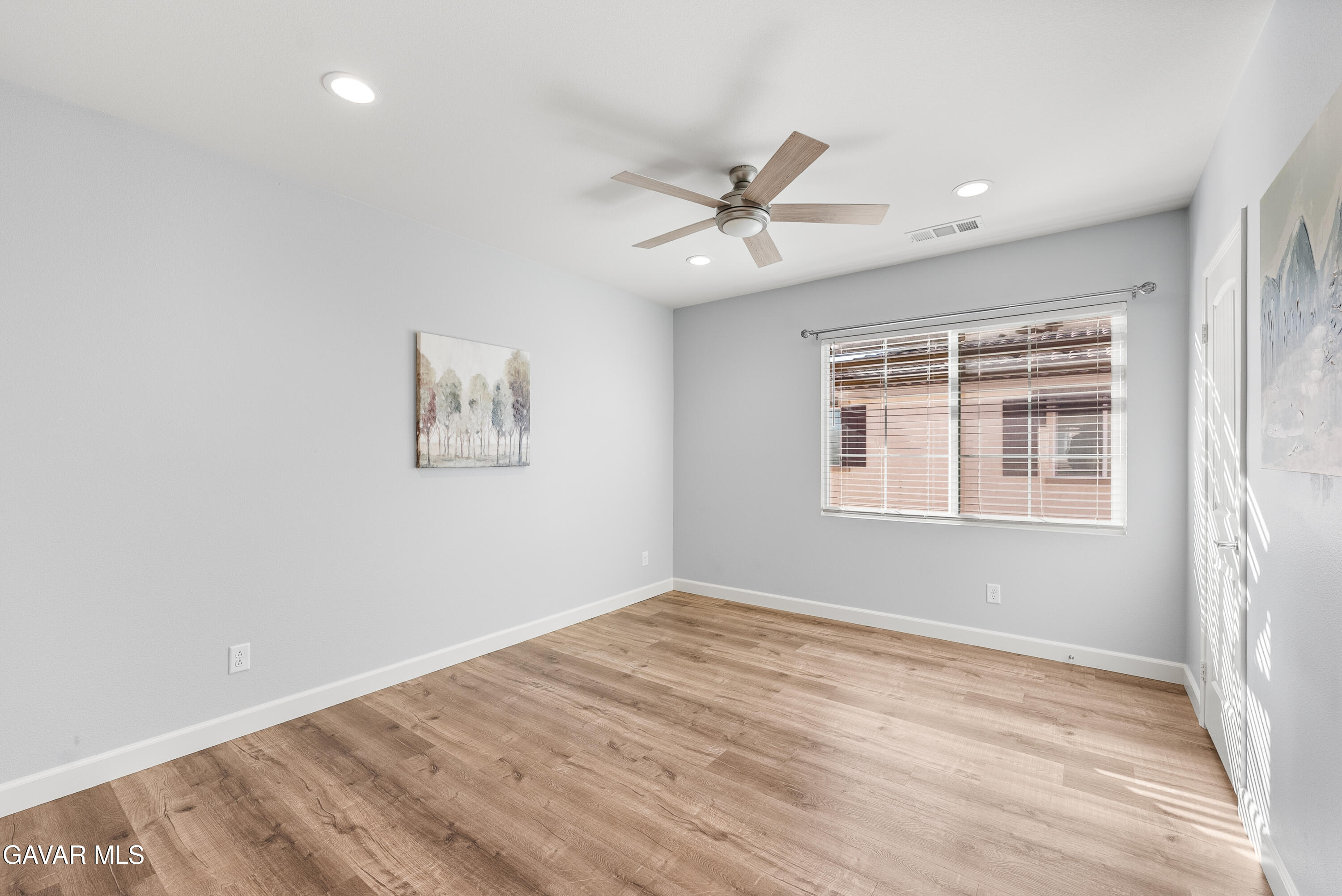 2108 Cork Oak Street Palmdale, CA 93551 - Photo 10 of 55 a view of empty room with wooden floor and fan