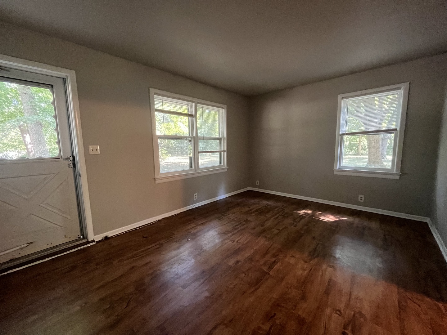 17206 South Lily Cache Road Plainfield, IL 60586 - Photo 2 of 7 an empty room with wooden floor and windows