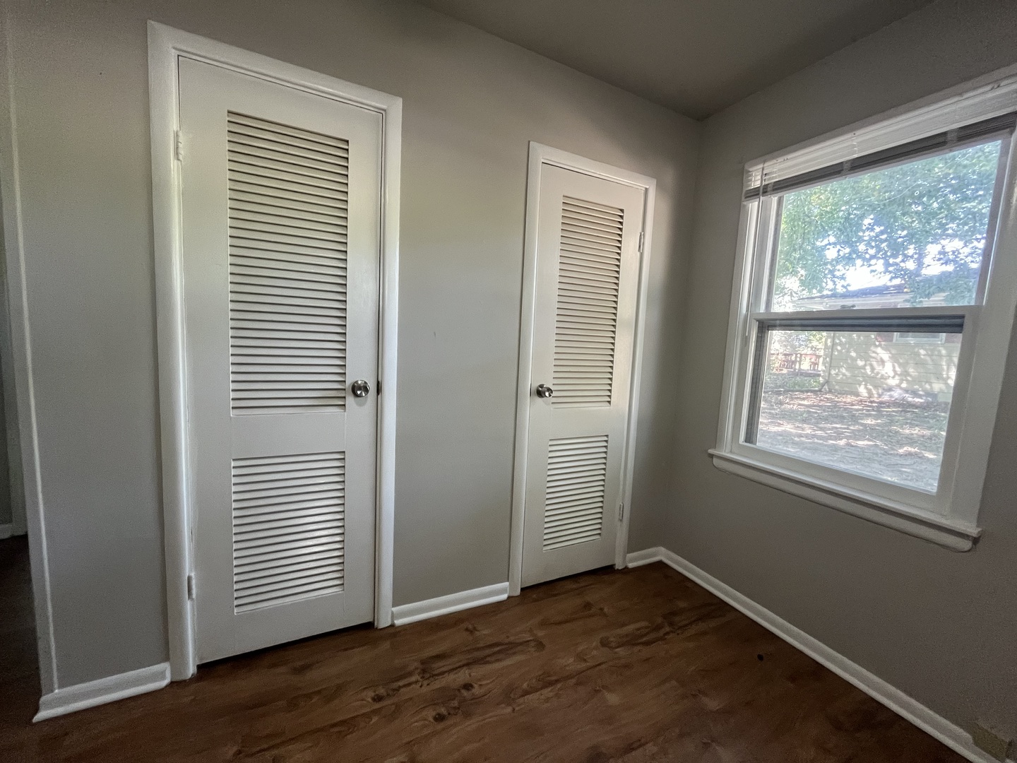 17206 South Lily Cache Road Plainfield, IL 60586 - Photo 5 of 7 an empty room with wooden floor and windows