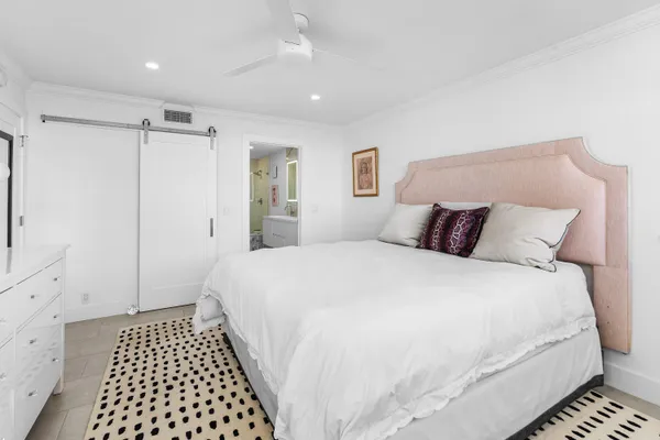 a bedroom with a bed and a walk in closet