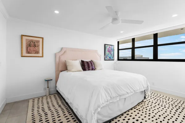 a bedroom with a bed and a painting on the wall
