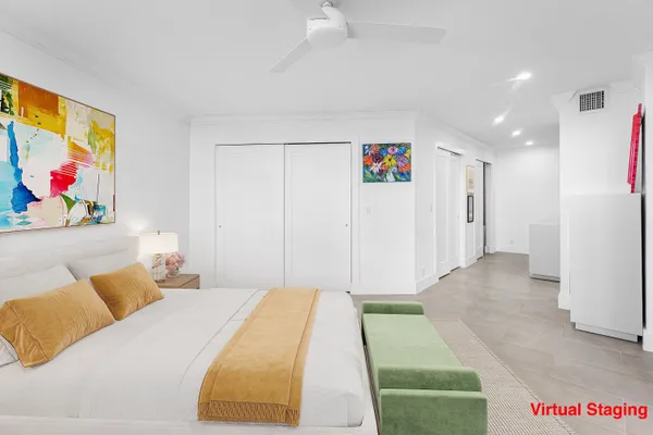 a bedroom with a bed and a painting on the wall