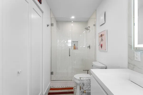 a bathroom with a sink toilet and shower