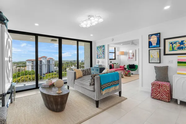 a living room with furniture and a floor to ceiling window