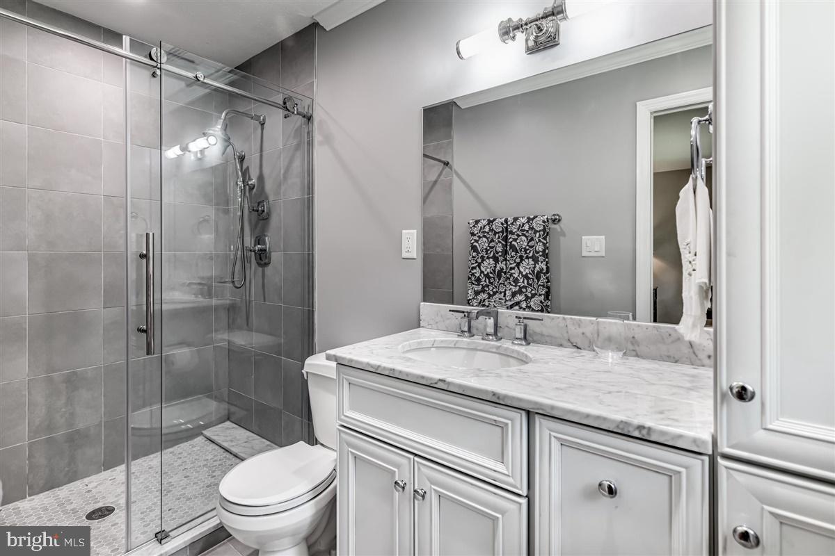 396 Riverside Drive Princeton, NJ 08540 - Photo 22 of 39 a bathroom with a granite countertop sink toilet mirror and shower