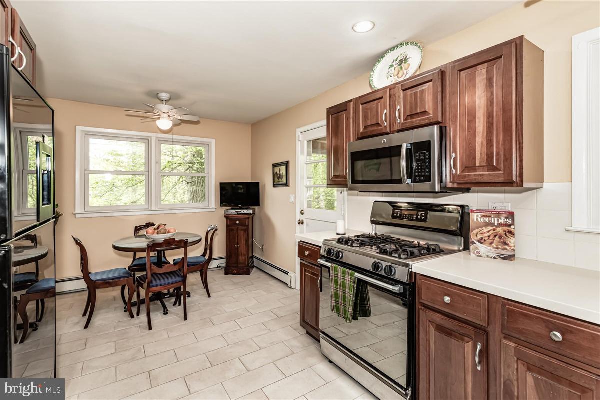 396 Riverside Drive Princeton, NJ 08540 - Photo 7 of 39 a kitchen with stainless steel appliances a stove a sink a microwave and a dining table