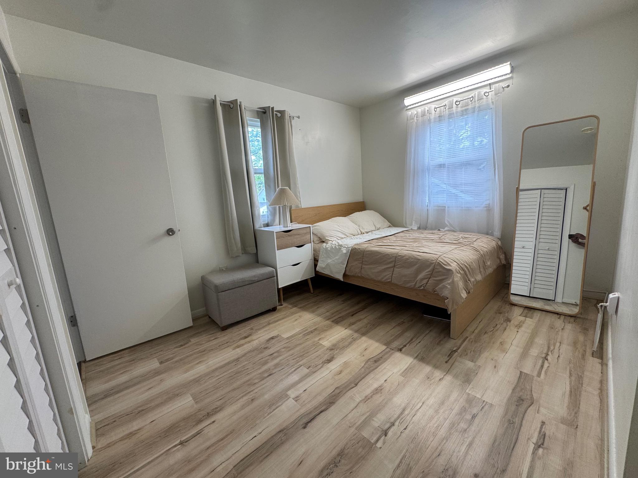 212 11th Street Laurel, MD 20707 - Photo 15 of 39 a bedroom with a bed and a mirror