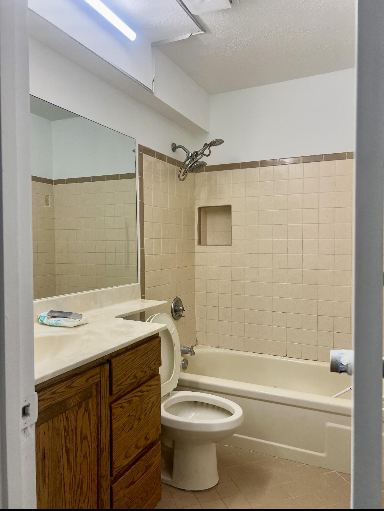 952 Southeast Walters Terrace Port St. Lucie, FL 34983 - Photo 12 of 14 a bathroom with a sink a toilet and shower