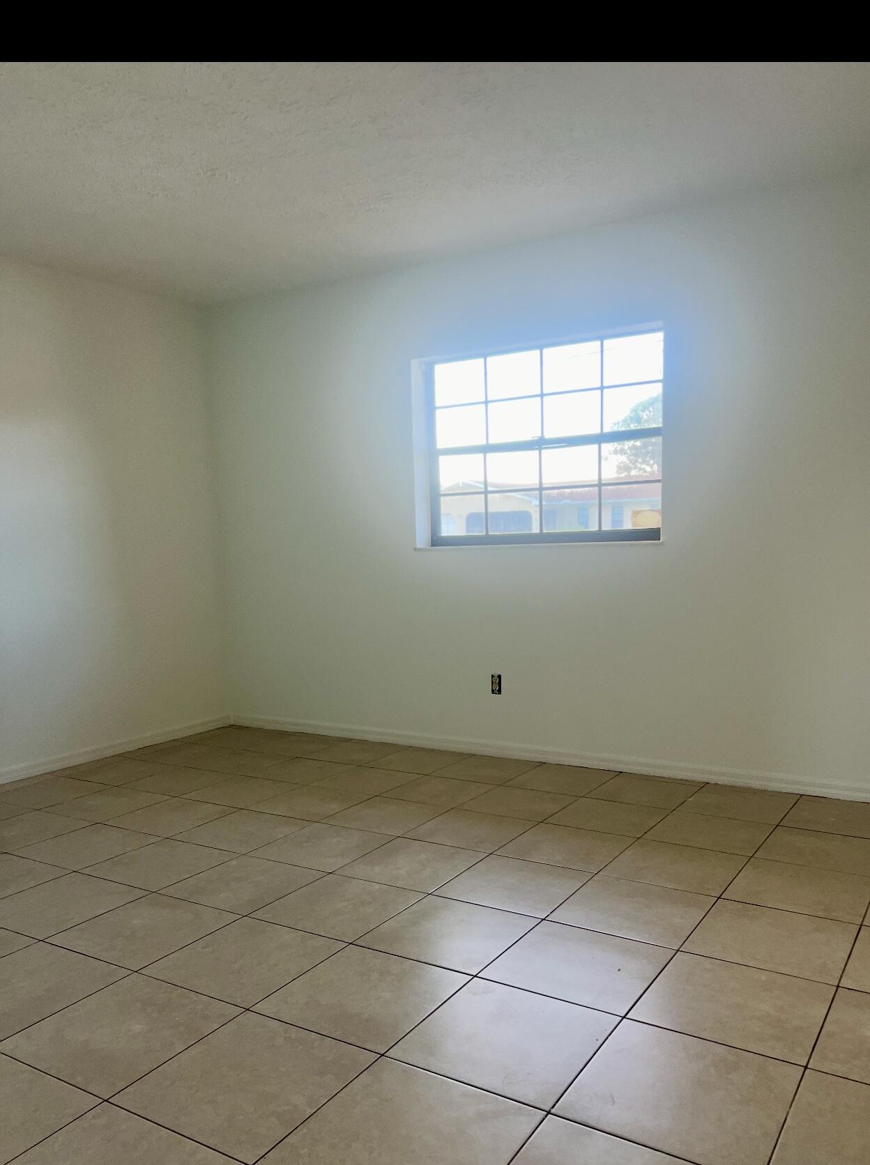 952 Southeast Walters Terrace Port St. Lucie, FL 34983 - Photo 13 of 14 a view of an empty room and a window