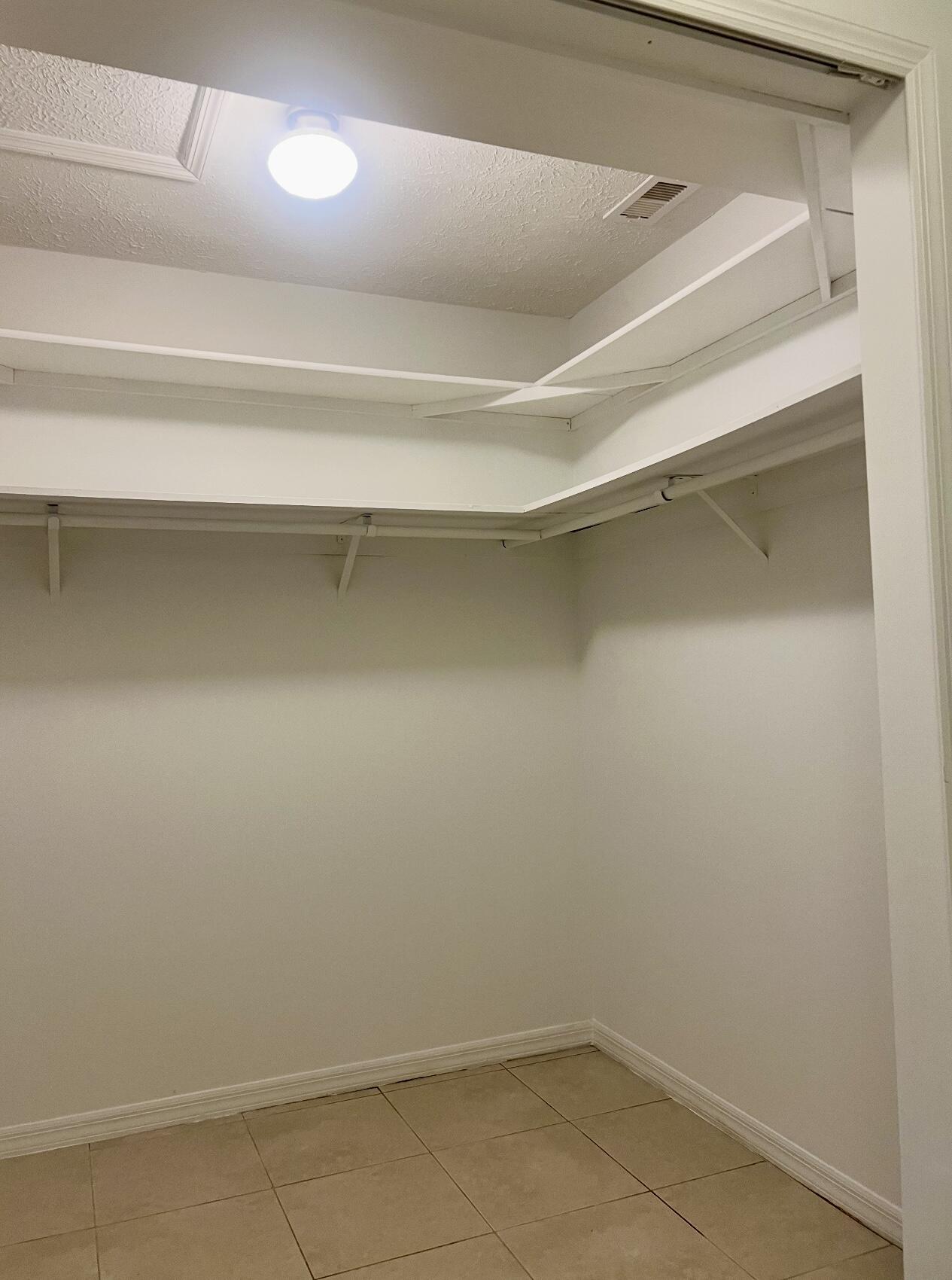 952 Southeast Walters Terrace Port St. Lucie, FL 34983 - Photo 14 of 14 a view of an empty walk in closet