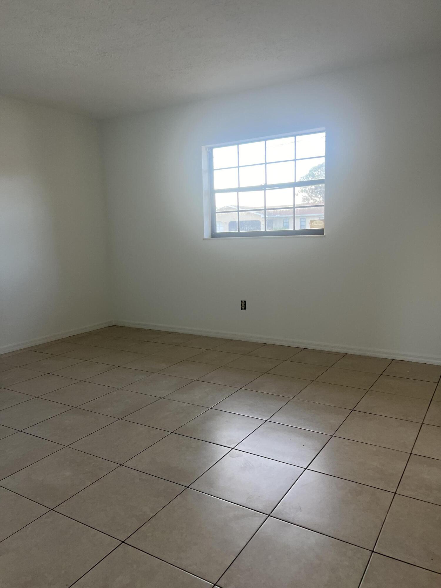 952 Southeast Walters Terrace Port St. Lucie, FL 34983 - Photo 3 of 14 an empty room with windows