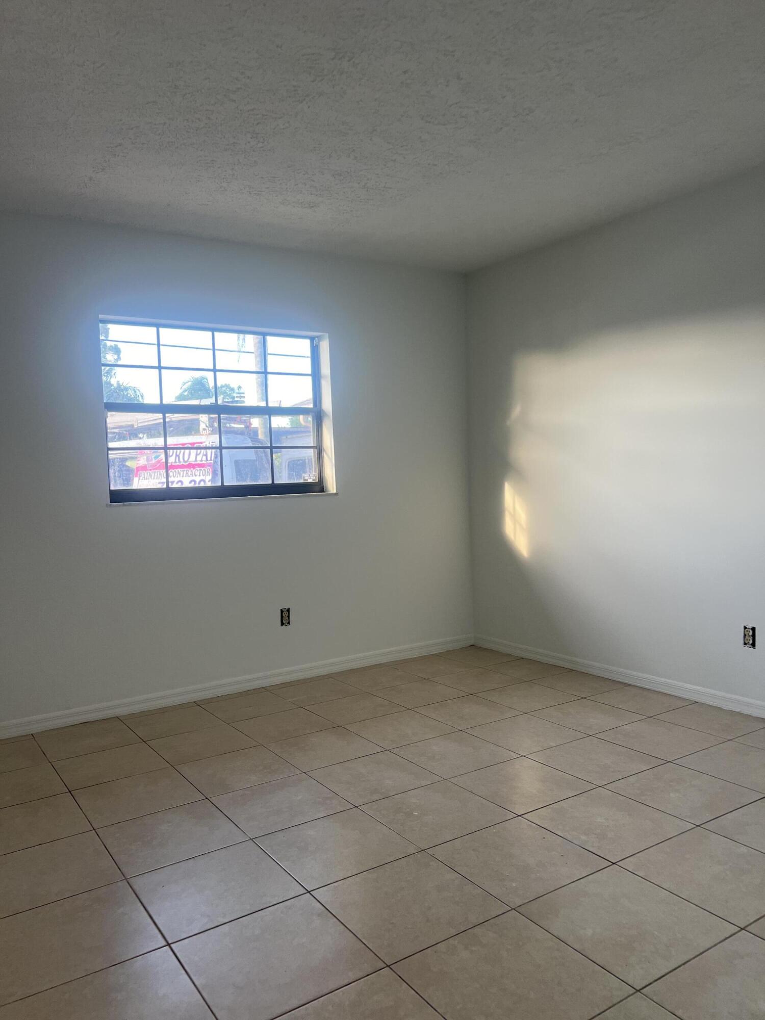 952 Southeast Walters Terrace Port St. Lucie, FL 34983 - Photo 4 of 14 an empty room with windows