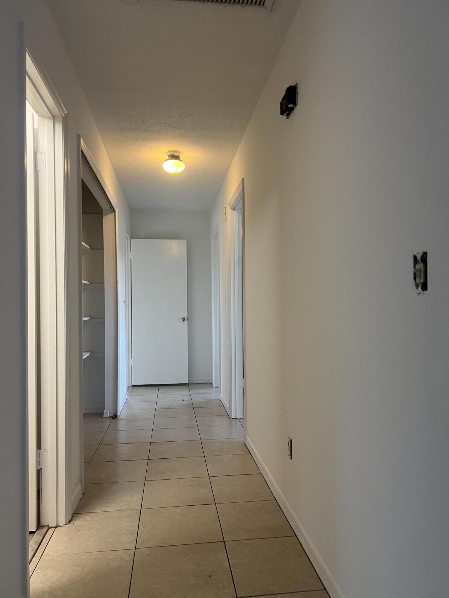 952 Southeast Walters Terrace Port St. Lucie, FL 34983 - Photo 6 of 14 a view of a hallway