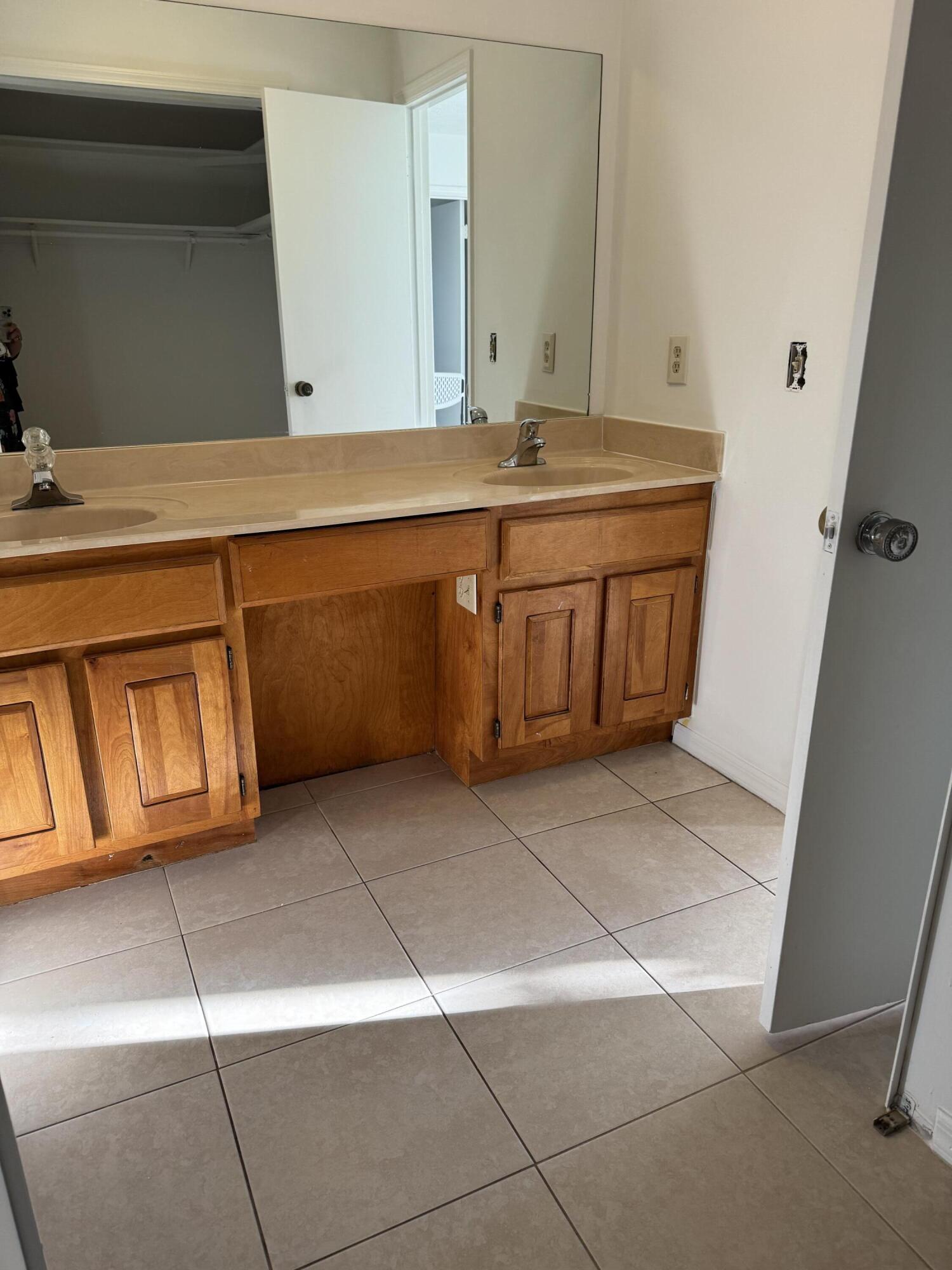 952 Southeast Walters Terrace Port St. Lucie, FL 34983 - Photo 10 of 14 a bathroom with a sink and a mirror