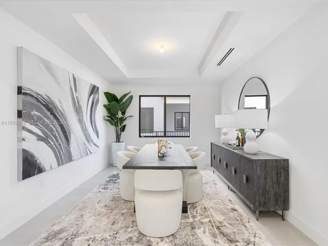 a living room with furniture kitchen view and a large window