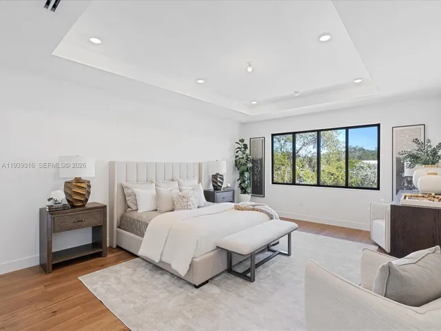 an aerial view of a house with a garden and lake view