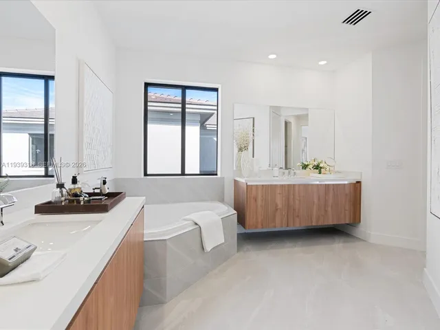a kitchen with granite countertop a sink a counter top space and living room area