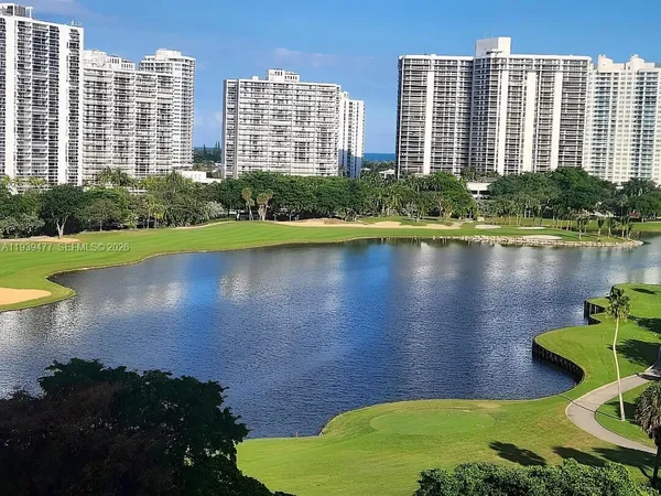 a view of a house with a yard and a lake view