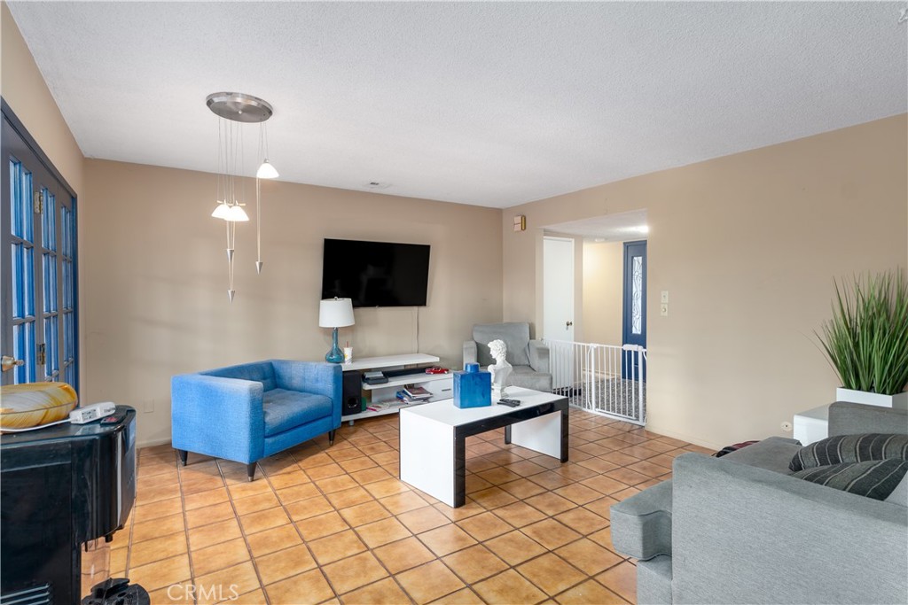 4967 Chapala Drive Riverside, CA 92507 - Photo 13 of 34 a living room with furniture and a flat screen tv
