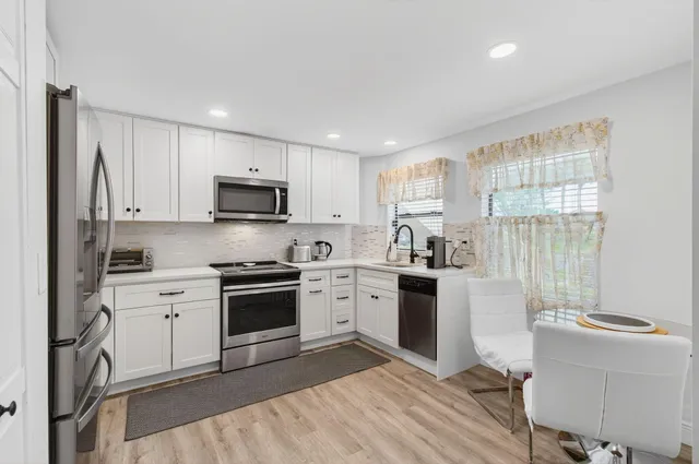 a kitchen with a sink stove and refrigerator