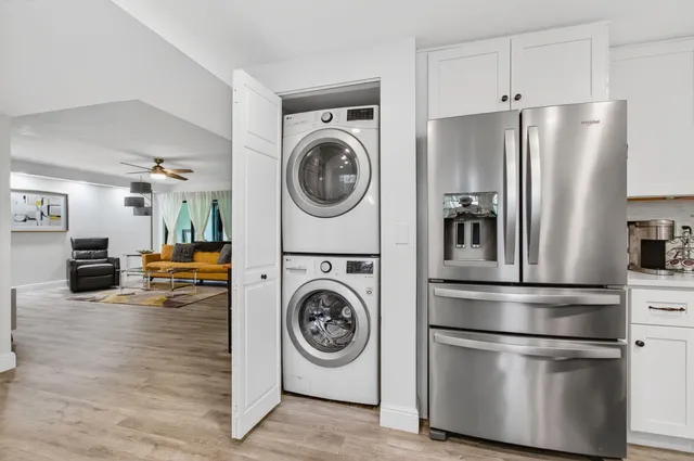 a kitchen with a refrigerator and washer