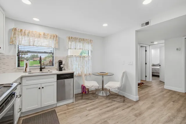 a living room with a sink and a large window