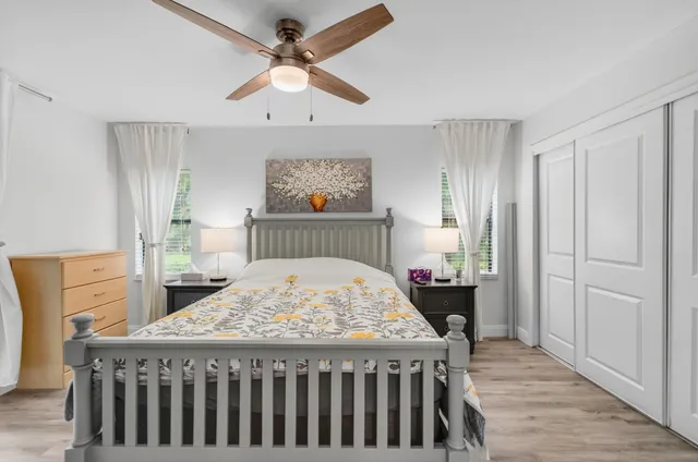 a bed sitting in a bedroom next to a window