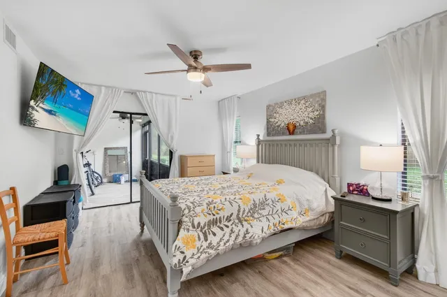 a bedroom with a bed and a flat tv screen