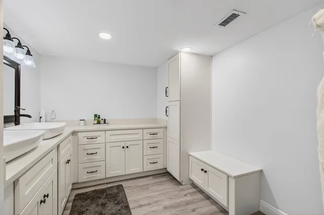 a spacious bathroom with a double vanity sink and mirror