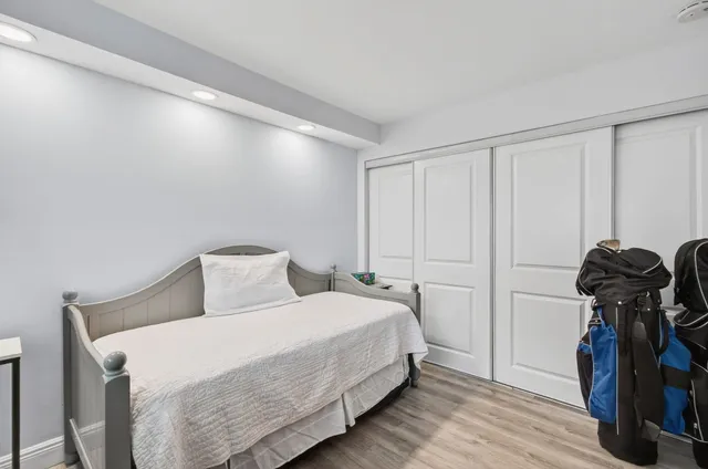 a bedroom with a bed and a mirror