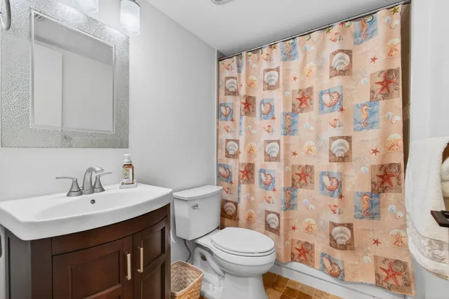 a bathroom with a sink toilet and shower