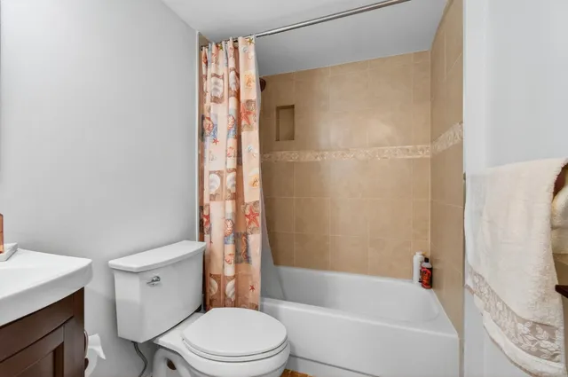 a bathroom with a toilet and shower
