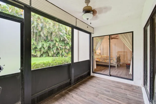 a view of an entryway with wooden floor and door