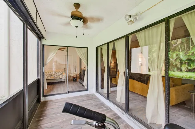 a bedroom with furniture and a large window