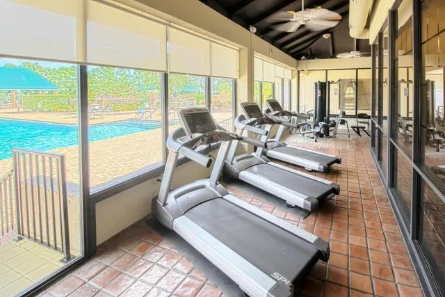a view of a living room with furniture and floor to ceiling windows