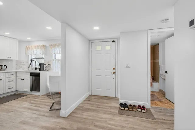 a kitchen with a refrigerator and a stove top oven