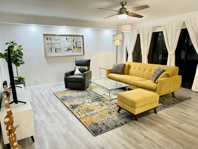 a living room with furniture and wooden floor