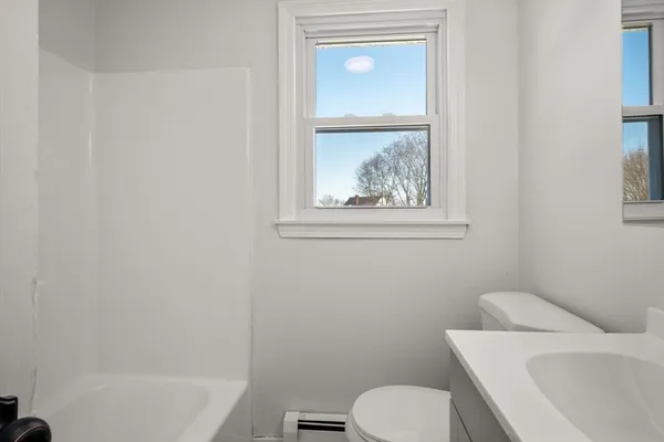 a white toilet sitting next to a bathroom sink