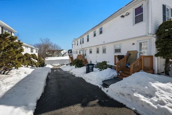 a car parked in front of white house
