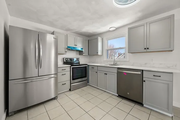 a kitchen with stainless steel appliances granite countertop a refrigerator sink and cabinets