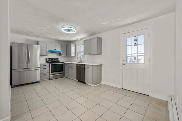 a kitchen with stainless steel appliances granite countertop a stove a sink and a refrigerator