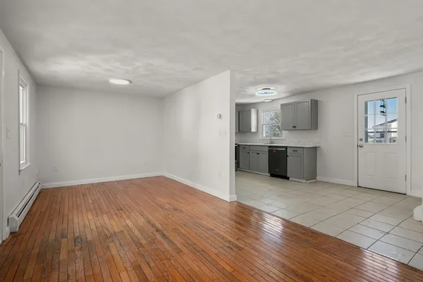 a view of a kitchen with wooden floor