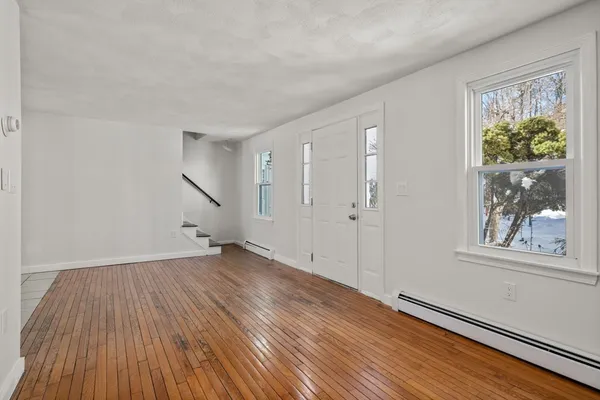 wooden floor in an empty room with a window