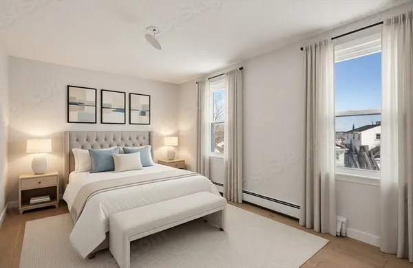 a bedroom with a bed and a window