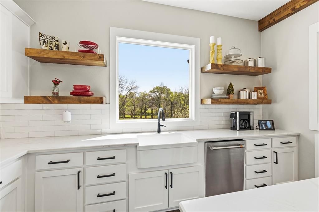 108 Golf Walk Circle Denison, TX 75020 - Photo 15 of 40 a kitchen with cabinets appliances and a window