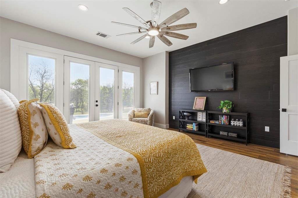 108 Golf Walk Circle Denison, TX 75020 - Photo 18 of 40 a bedroom with a bed and a flat screen tv